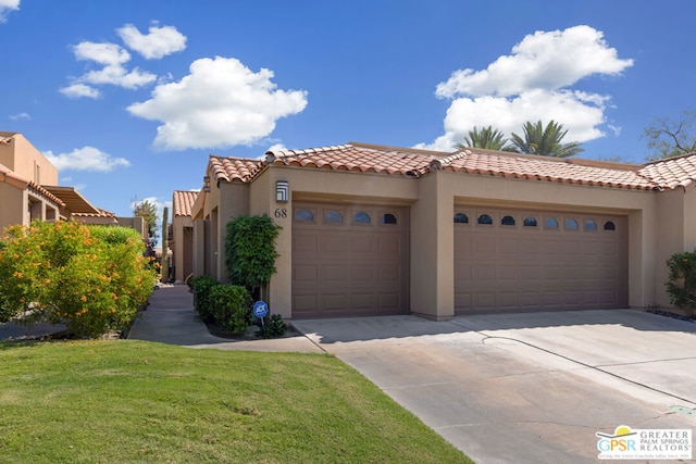 mediterranean / spanish-style home with a front yard and a garage