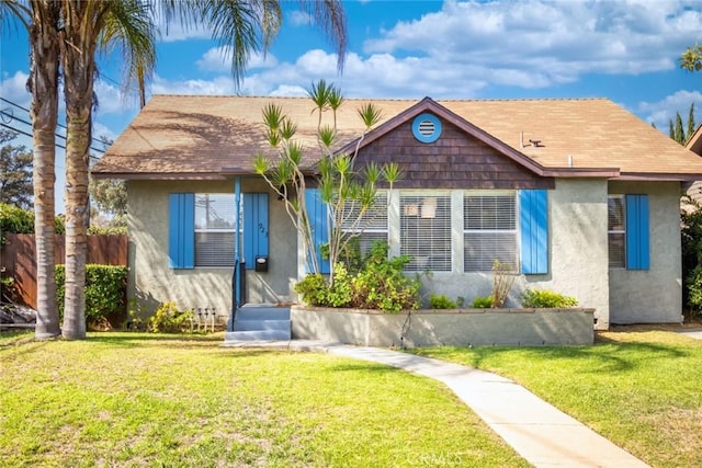 bungalow-style home featuring a front yard