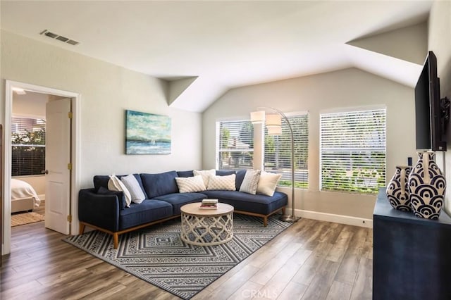 living room with wood-type flooring and vaulted ceiling