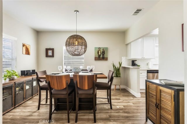 dining space featuring light wood-type flooring