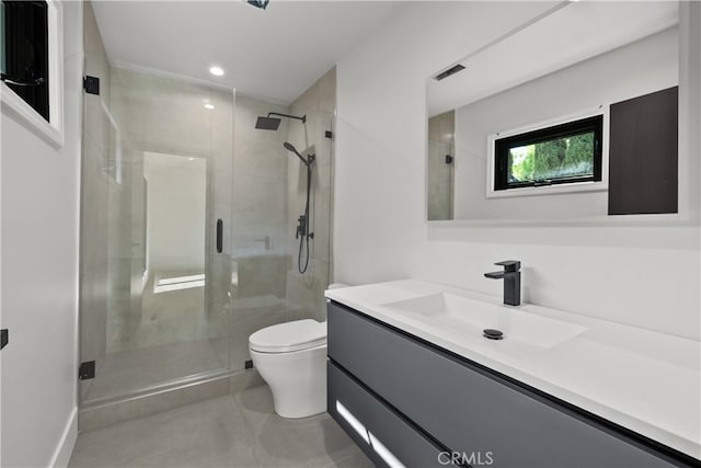 bathroom with walk in shower, vanity, and toilet