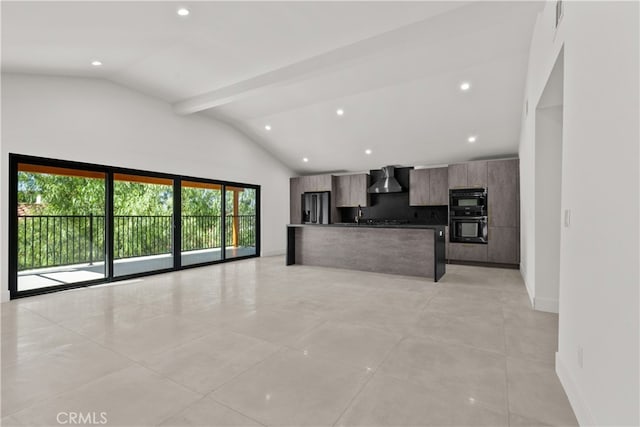 kitchen featuring an island with sink, wall chimney range hood, lofted ceiling with beams, a breakfast bar, and refrigerator with ice dispenser