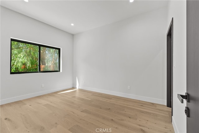 spare room with light wood-type flooring