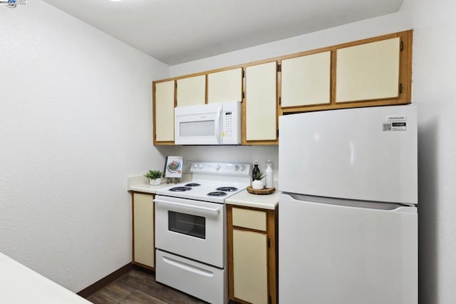 kitchen featuring dark hardwood / wood-style floors and white appliances