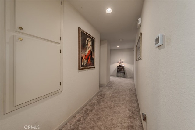 corridor with light colored carpet