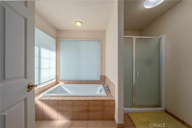 bathroom featuring tile patterned flooring and shower with separate bathtub