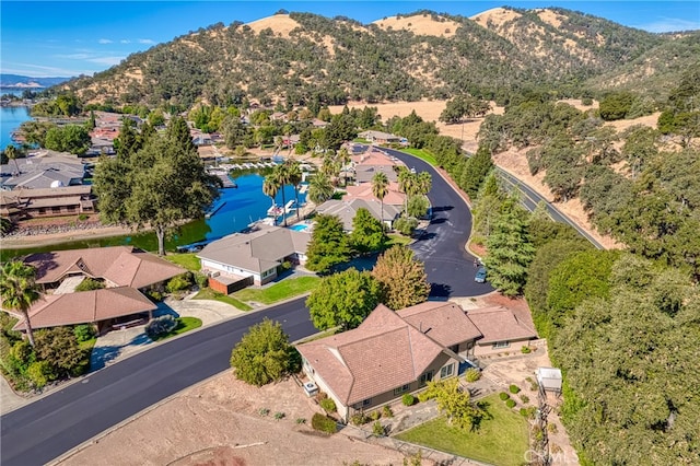 birds eye view of property with a water and mountain view