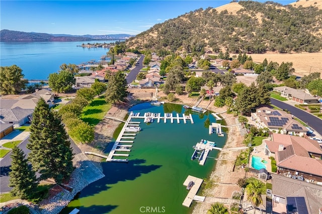 birds eye view of property with a water and mountain view