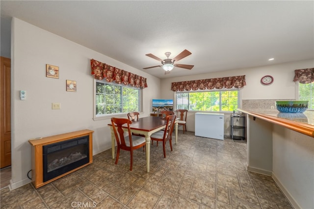 dining space with ceiling fan and a healthy amount of sunlight