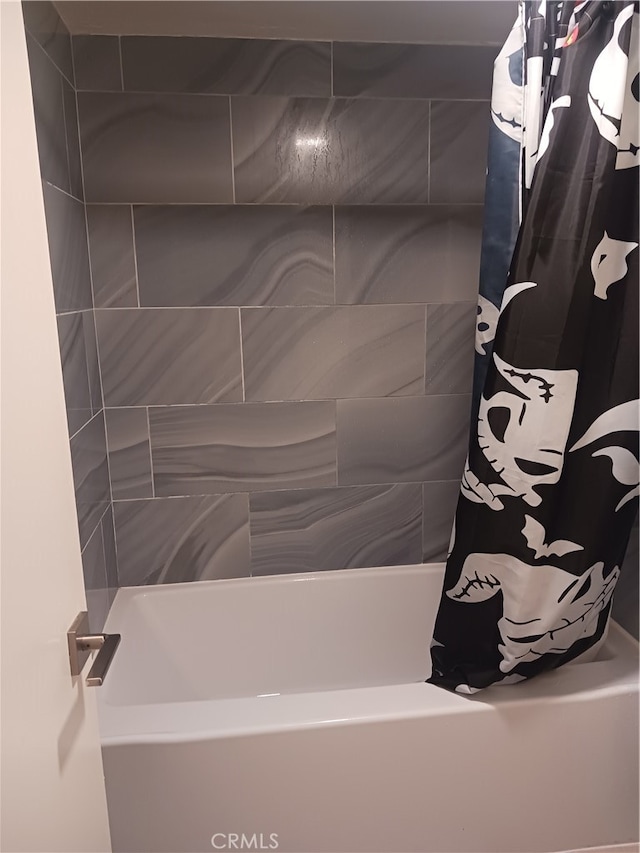 bathroom with shower / tub combo with curtain