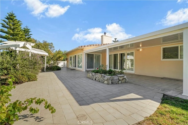 back of house with a patio