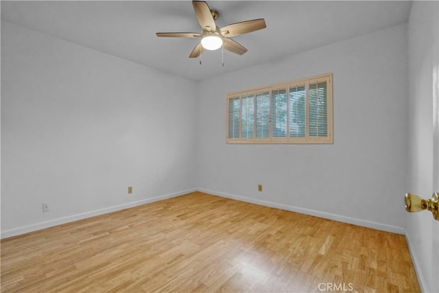 spare room with ceiling fan and light wood-type flooring