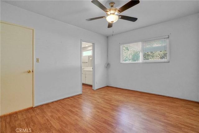 empty room with ceiling fan and light hardwood / wood-style floors