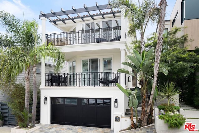 view of front facade with a balcony and a garage