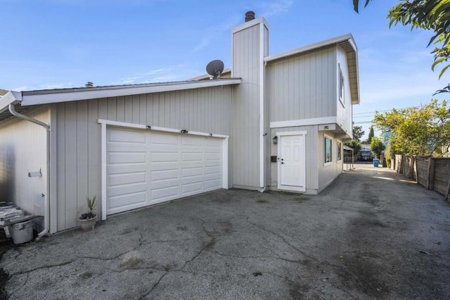 rear view of property with a garage