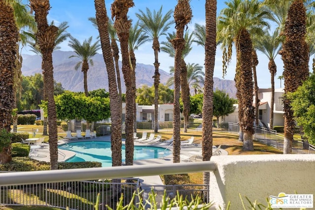 view of swimming pool featuring a patio and a mountain view