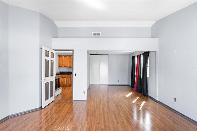 20664 Brana Rd, Riverside, CA 92508 - unfurnished bedroom with light wood-type flooring, baseboards, and lofted ceiling