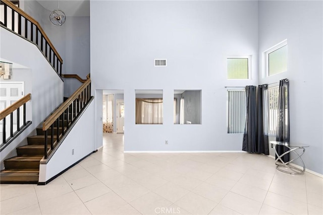 20664 Brana Rd, Riverside, CA 92508 - unfurnished living room featuring a high ceiling, stairs, and baseboards