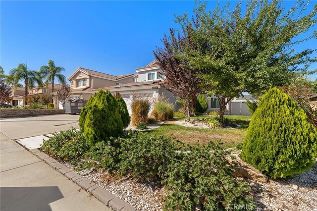 20664 Brana Rd, Riverside, CA 92508 - view of property hidden behind natural elements with stucco siding and driveway