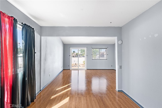 unfurnished room with hardwood / wood-style floors