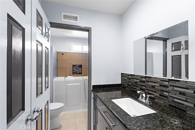 20664 Brana Rd, Riverside, CA 92508 - bathroom featuring toilet, vanity, tile patterned floors, a bathtub, and washing machine and clothes dryer