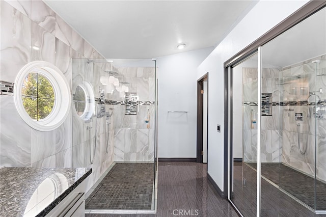 bathroom featuring vanity and a shower with shower door