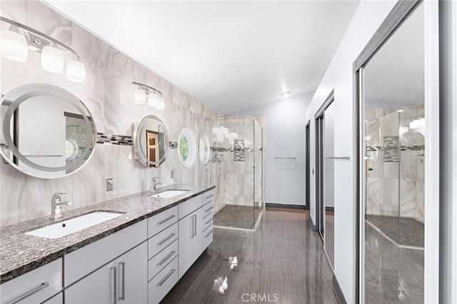 20664 Brana Rd, Riverside, CA 92508 - full bathroom with double vanity, a stall shower, and baseboards