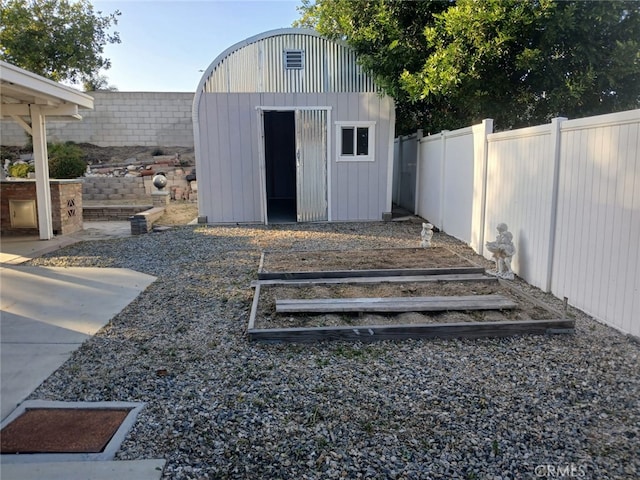 20664 Brana Rd, Riverside, CA 92508 - view of shed featuring a fenced backyard and a vegetable garden