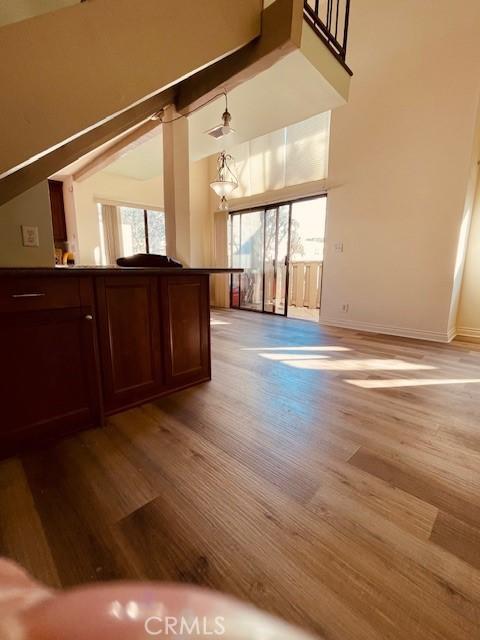 interior space featuring ceiling fan, light hardwood / wood-style flooring, and vaulted ceiling