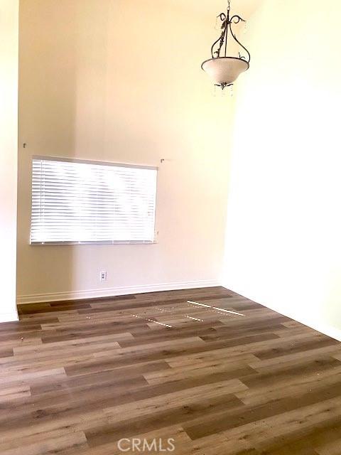 unfurnished room with dark wood-type flooring