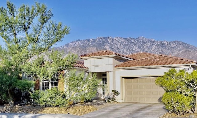 mediterranean / spanish-style home featuring a mountain view and a garage