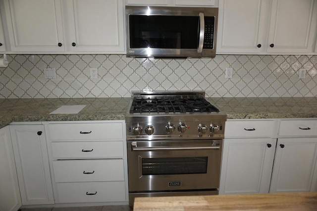 kitchen featuring light stone countertops, decorative backsplash, white cabinets, and stainless steel appliances