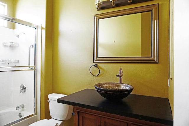 full bathroom featuring vanity, washtub / shower combination, and toilet