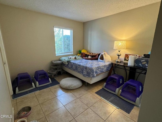 bedroom featuring light tile patterned flooring and a textured ceiling