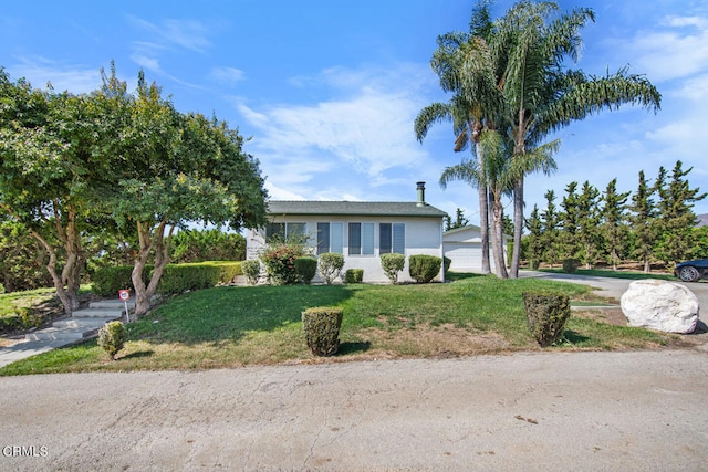 ranch-style home with a front yard and a garage