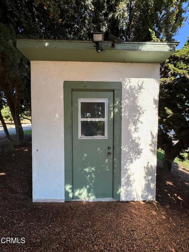 view of storm shelter with a shed