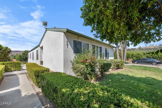 view of side of property with a yard