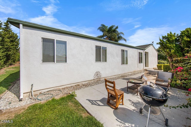 back of property featuring a patio and a fire pit