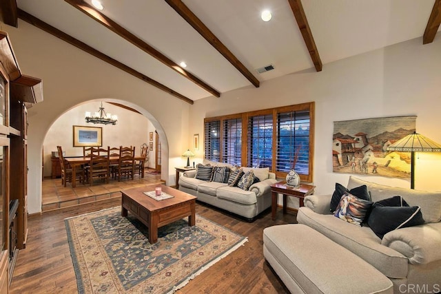 living room with a chandelier, lofted ceiling with beams, and dark hardwood / wood-style flooring