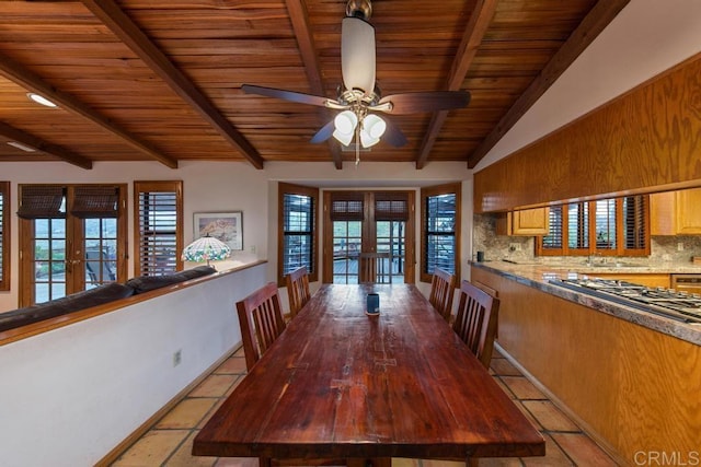 unfurnished dining area featuring ceiling fan, wood ceiling, sink, french doors, and vaulted ceiling with beams