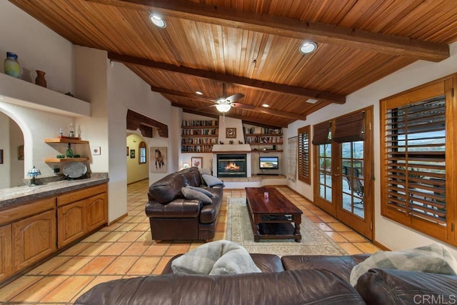 tiled living room featuring french doors, vaulted ceiling with beams, ceiling fan, and wooden ceiling