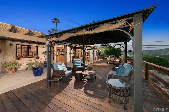 wooden terrace featuring outdoor lounge area and a gazebo