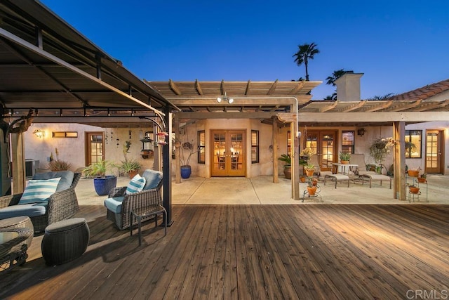 deck at dusk with french doors, an outdoor hangout area, a patio area, and central AC