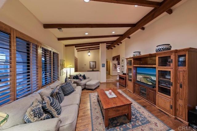 living room with wood-type flooring and lofted ceiling with beams