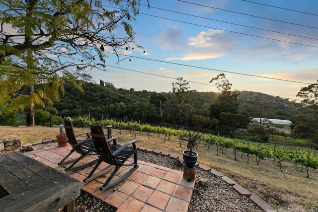 12622 Sierra Rojo, Valley Center, CA 92082 - patio terrace at dusk with a patio area and a view of countryside