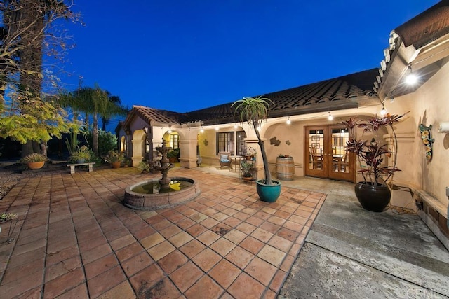 12622 Sierra Rojo, Valley Center, CA 92082 - patio at twilight featuring french doors and a patio