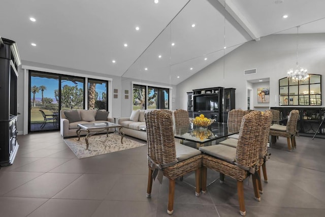 dining area with high vaulted ceiling and an inviting chandelier