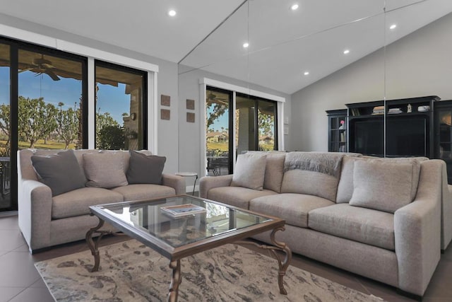 living room featuring tile patterned floors, ceiling fan, and vaulted ceiling