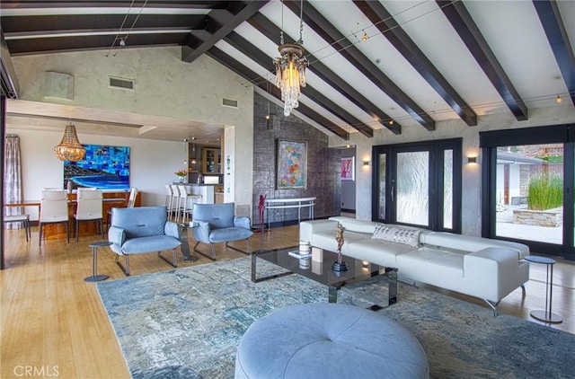 living room featuring high vaulted ceiling, beam ceiling, a notable chandelier, and hardwood / wood-style flooring