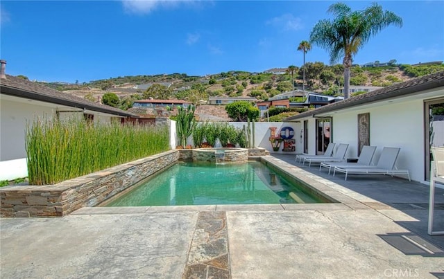 view of pool with a patio and an in ground hot tub